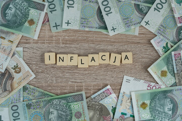Word inflacja in Polish language, means inflation. Flat lay composition with złoty money, PLN...