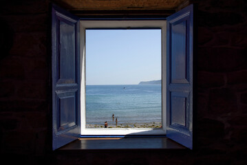 blue window open to the sea and beach