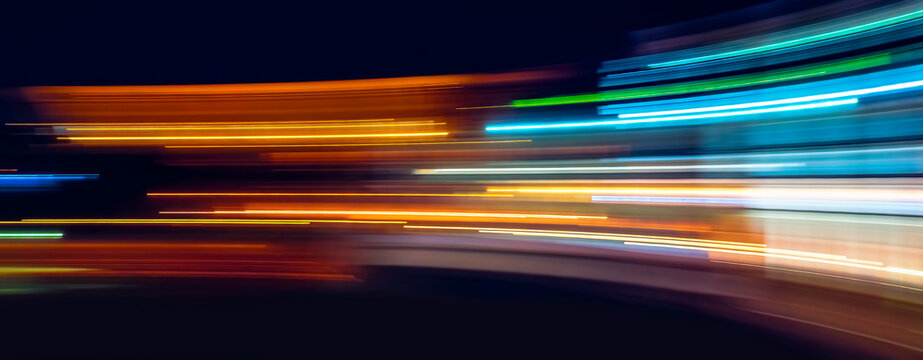 Abstract Rainbow light trails on the dark background