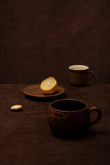 Obraz na płótnie Canvas Still life with brown cups and lemon