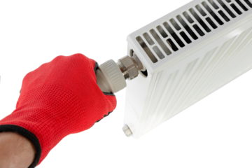 technician tightening central heating radiator fitting, close-up on isolated white