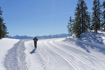 Wonderful wintertime, winter mountain landscape, sunny day. Single hiker explore the mountain route...