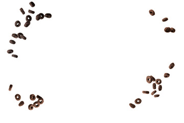 Chocolate rings cereal spill out into a bowl. Breakfast.