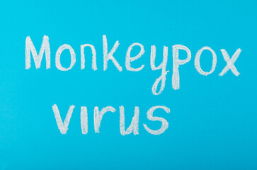Chalk inscription MONKEYPOX VIRUS on a colored textured background.