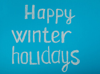 Chalk inscription HAPPY WINTER HOLIDAY or MERRY CHRISTMAS. Winter holidays. Celebration. Weekend.