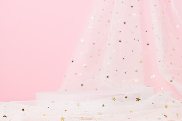 Blank cylinder podium on glitter textile fabric on pink background. Cute, glamour showcase for...