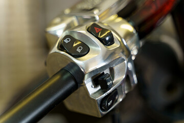 The handle of the throttle and control of lighting devices on the handlebars of a motorcycle.