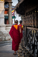 Buddhist monks rolling the prayer wheels at  monkey temple / stupa in kathmandu nepal Swayambhu...