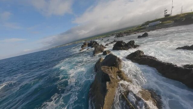 FPV drone shot flying above sea and rock in Rishiri Island Hokkaido Japan