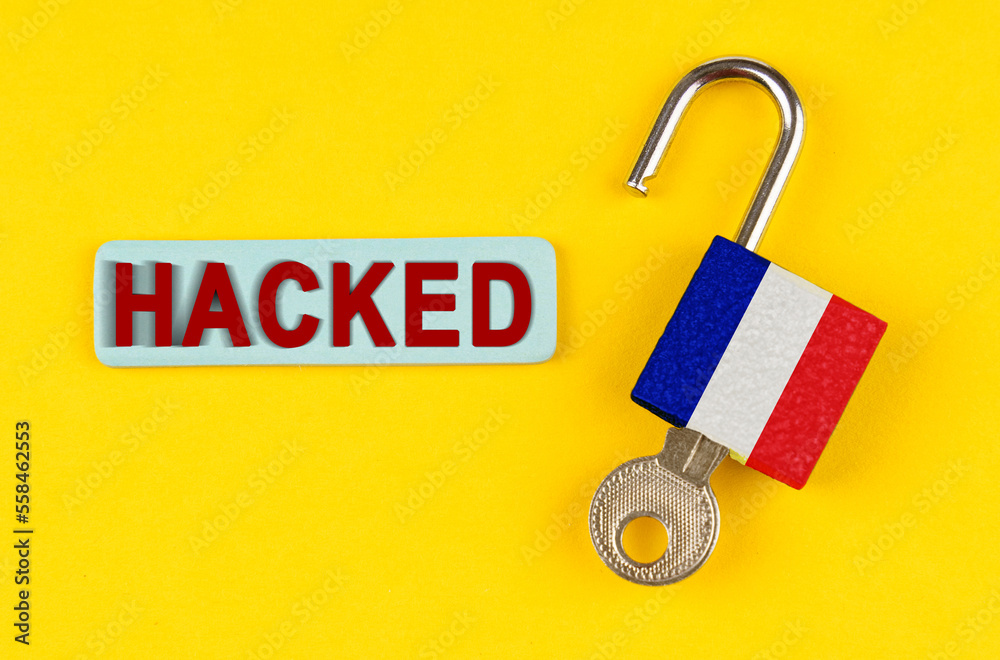 Aufkleber on the yellow surface is an open lock with a key and a sticker with the inscription - hacked