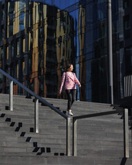 Fototapeta premium business woman in pink jacket goes to work in office, entrepreneur. successful, confident startup female is in hurry to job in large financial company or for interview, negotiations with partners.