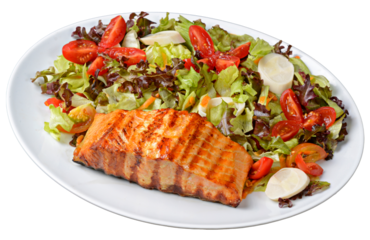 Grilled salmon with green salad with heart of palm and cherry tomatoes in white plate isolated on transparent background.