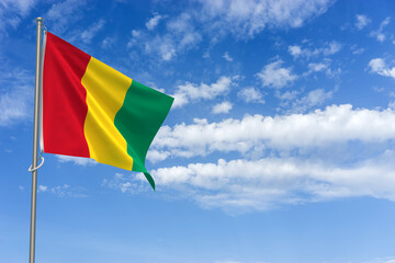 Republic of Guinea Flag Over Blue Sky Background. 3D Illustration