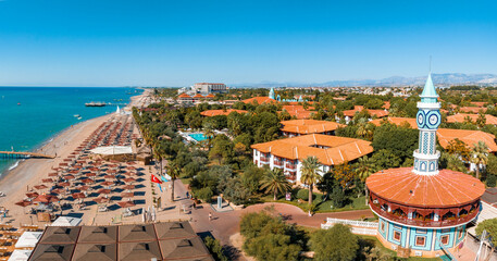 Luxury tropical hotel resort. Outdoor tourism landscape. Luxurious beach resort with swimming pool and beach chairs and palm trees. Summer island relax travel and idyllic vacation