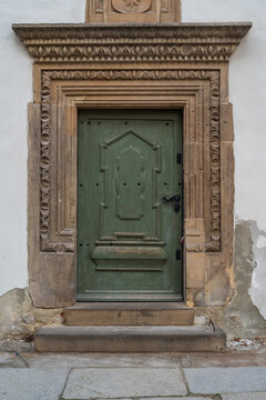 Elegant Old Doors Adorned With Intricate Details In A Decorated Façade Of A Historical Significant Building, Well-maintained, Showing The Craftsmanship Of The Ornate Carvings And Moldings.