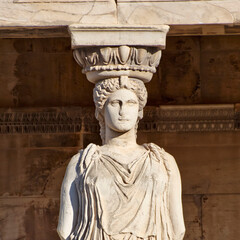 A Caryatid, feminine figure statue at Erechtheion ancient Greek temple, on Acropolis hill. Cultural travel in Athens, Greece.