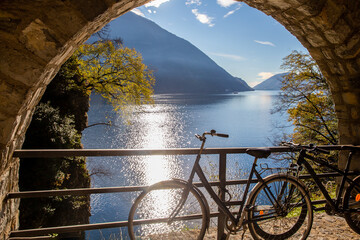 Bicycles on Olive trail   so turn (turn fortified) and nature in distance  on lake Lugano