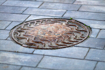 A cast-iron old well on the pavement