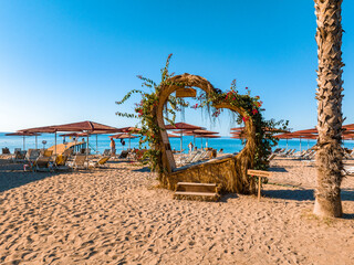 Beautiful place for the Instagram photos on the beach in the luxury beach resort. Wooden vintage heart on the beach.