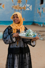 A Nubian girl carrying a teapot - obrazy, fototapety, plakaty