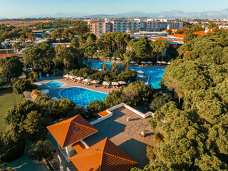 Aerial view of the outdoor swimming pool in a luxury hotel. Luxury vacation and holiday concept. Sunset sunrise landscape, outdoor scenic views.