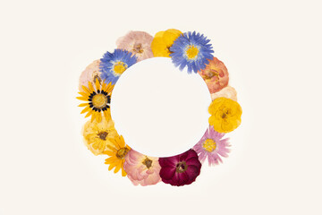 Composition of pressed dried flowers of asters and garden roses in the form of a circle. Mockup for greeting card, wedding invitation.