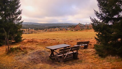 Fototapeta premium A sunrise above the cottages in meadows at Filipova Hut, Czech republic