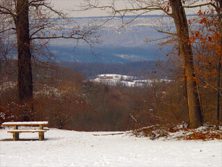 bench in the snow, house in the distance