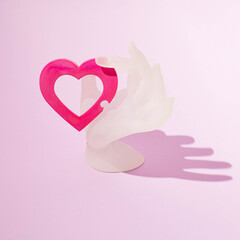 pink heart in glass hand