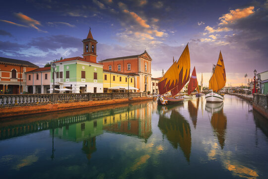 Cesenatico canal, historic sailboats and church. Romagna, Italy