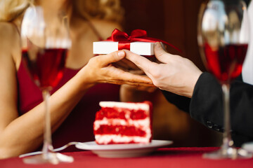 Man presenting gift to his girlfriend.Valentine's day celebration. Relationship and love concept. 