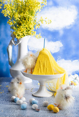 Traditional Easter Orthodox curd cake with yellow flowers against a blue sky 