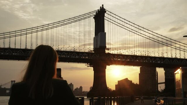 Woman Taking A Picture Of Manhattan Bridge