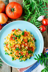 Bulgur with carrots, onions, bell peppers and green peas