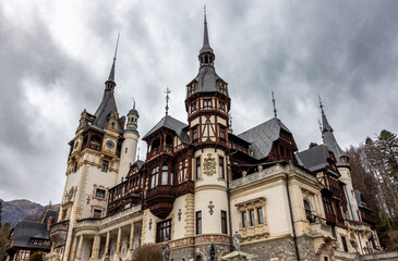 Fototapeta na wymiar Peles castle at cloudy day. Sinaia city, Romania.