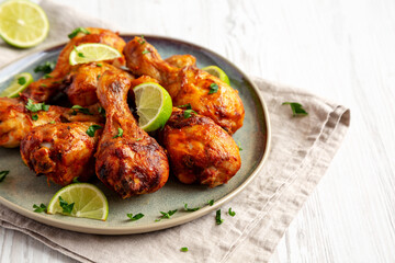 Homemade Grilled Jerk Chicken with Lime on a Plate, side view. Space for text.