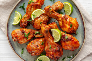 Homemade Grilled Jerk Chicken with Lime on a Plate, top view. Flat lay, overhead, from above.