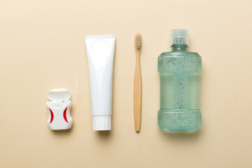 Mouthwash and other oral hygiene products on colored table top view with copy space. Flat lay. Dental hygiene. Oral care products and space for text on light background. concept