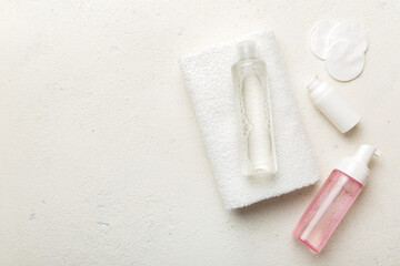 Micellar cleansing water and discs to remove cosmetics and cleanse the skin on colored background. Copy space top view