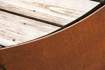 Detail of corten bench with wooden surface 