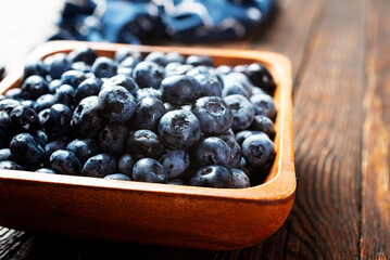 Freshly picked blueberries in wooden bowl. Juicy and fresh blueberries