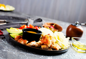 Cobb salad with sauce. Traditional american dish made of salad leaves, avocado, cherry tomatoes, fried chicken and spices