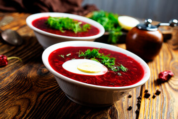 Traditional Ukrainian Russian borscht . Bowl of red beet root soup borsch with white cream . Beet Root delicious soup . Traditional Ukrainian food cuisine