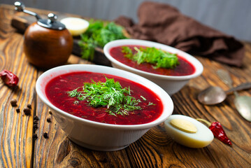 Traditional Ukrainian Russian borscht . Bowl of red beet root soup borsch with white cream . Beet Root delicious soup . Traditional Ukrainian food cuisine