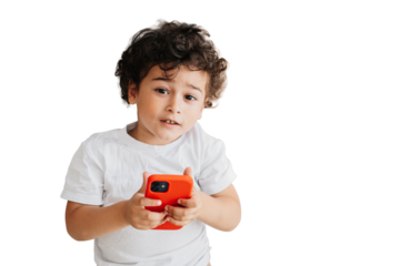 Portrait from top of handsome curly Brazilian curly boy  holding phone looking at camera over transparent background. Domestic leisure, children using gadgets. Handsome caucasian kid spends time home.