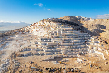 Industry marble quarry and cut white blocks, aerial top view Turkey sunlight