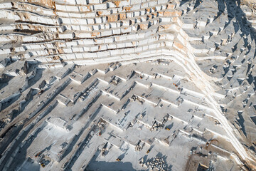 Turkey Industry marble quarry and cut white blocks with yellow track, aerial top view