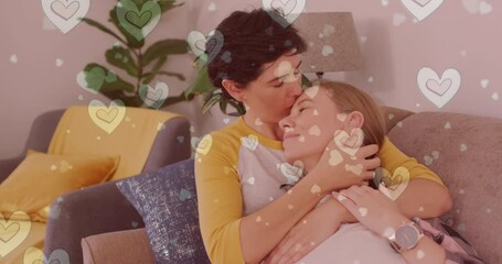 Animation of hearts over caucasian female couple sitting on sofa and embracing
