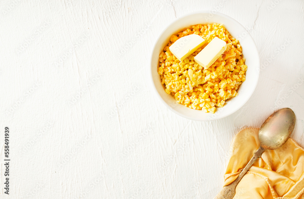 Poster barley porridge with butter in white bowl