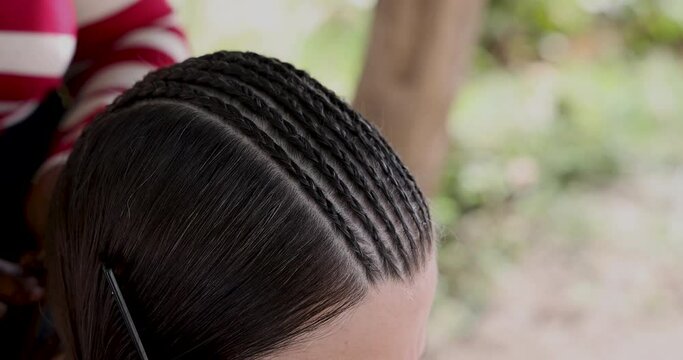 St Maarten island Caribbean Beautiful woman hair style. Beautiful woman her long dark hair braided by Caribbean stylist beautician. Fun African style corn rows with beads and jewelry. Tropical beach.